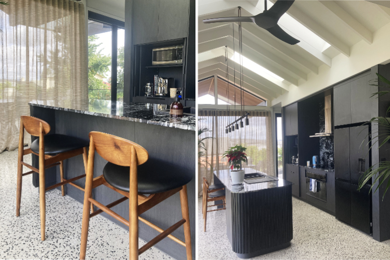 black and white kitchen with high raked gable ceiling with exposed beams, skylights, ceiling fan